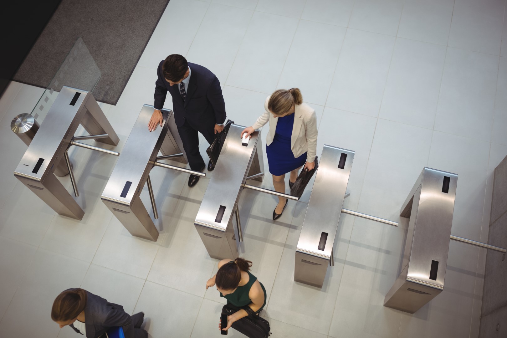 Top,View,Of,Business,Executives,Passing,Through,Turnstile,Gate